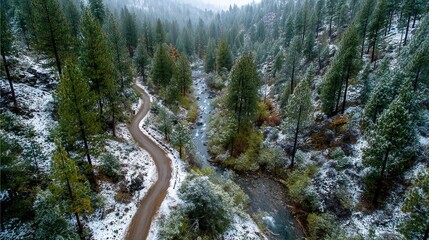 Snowy bike path along mountain ridge with distant valley view
