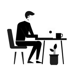 silhouette of a man working on a laptop