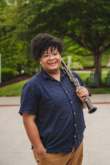 Man holding a clarinet and being silly