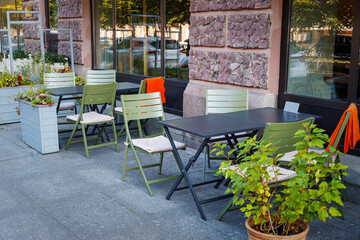 Outdoor cafe. There are empty tables and chairs in the outdoor summer cafe.