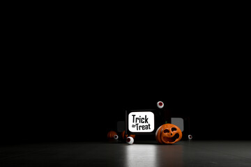 Halloween trick or treat with pumpkins, eyeballs and retro TV on dark background