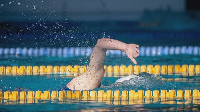 Cinemagraph. Swimmer swims freestyle swimming style in the pool.