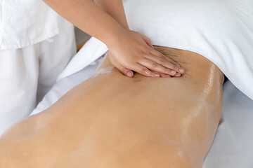 Caucasian man customer enjoying relaxing anti-stress spa massage and pampering with beauty skin recreation leisure in day light ambient salon spa at luxury resort or hotel. Quiescent