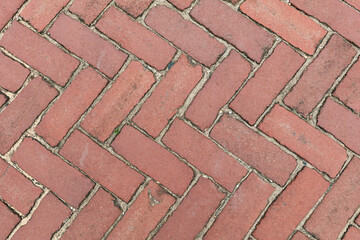 Herringbone brick pavement texture with mortar joints, top view