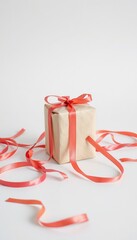 Gift wrapped in brown paper with pink ribbon on white background  