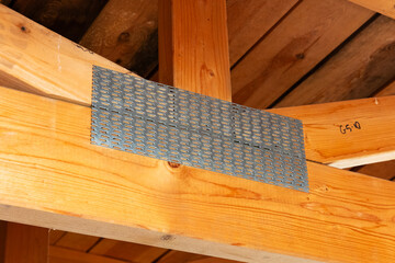 Timber roof trusses with metal connector plates, close‑up