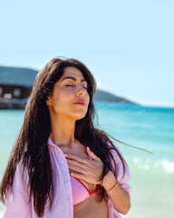 Beautiful  woman breathing fresh air on the beach. Breathing exercises 
