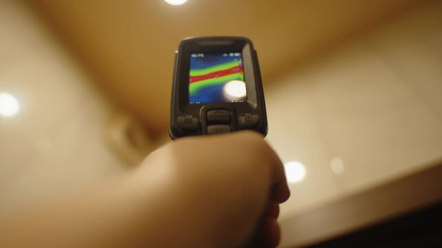 Hand holding thermal imager checking heat distribution