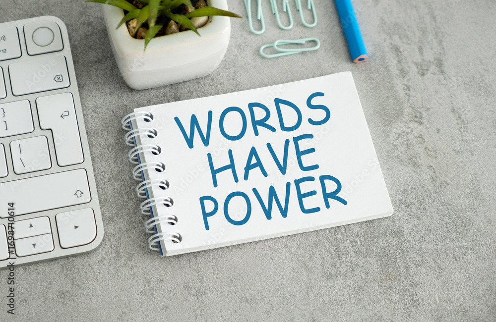 Poster words have power word on open notes with keyboard on gray background
