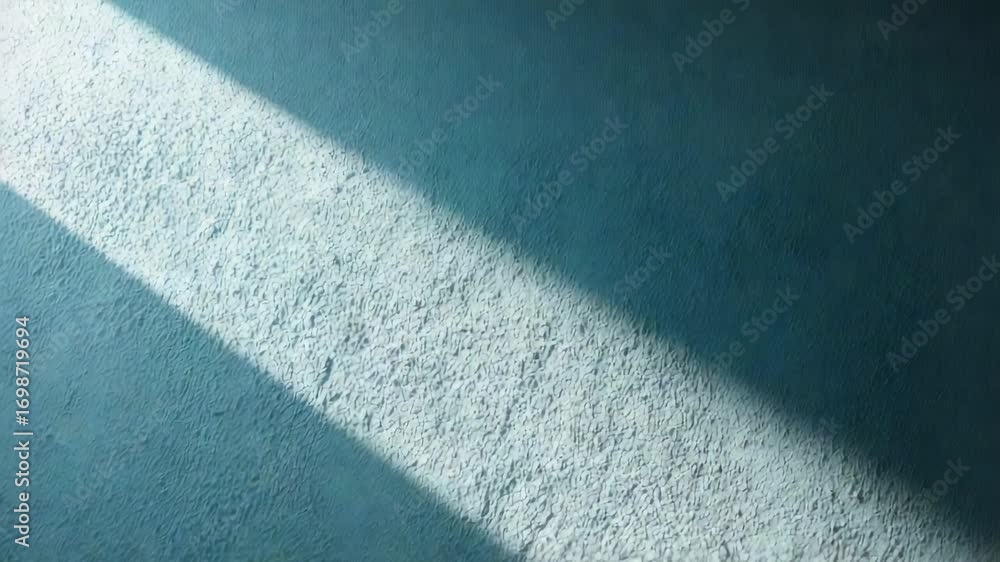Poster sunlight gradually moves across a textured teal wall, creating dynamic shadows that shift and change