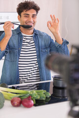 young chef blogger teasting food and gesturing its perfection