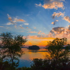 calm lake with forest silhouette on the coast at the twilight