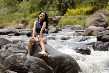 Discovering Nature: A Woman Smiling in a Forest Stream