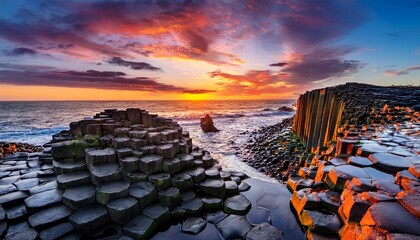 sunset over coastal rock formation with hexagonal basalt columns and vibrant sky reflecting on wet stone surface generative by ai