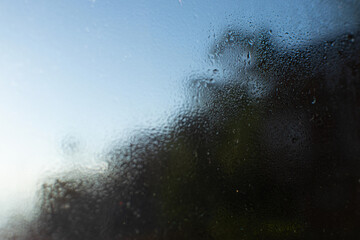 Sunrise shot behind glass filled with dew drops, abstract image, Kanchenjunga mountain range in the morning, Ravangla, Sikkim. Scenic view of great Himalaya, India,