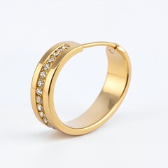 Elegant golden earring embellished with gemstones radiates luxurious appeal on white background