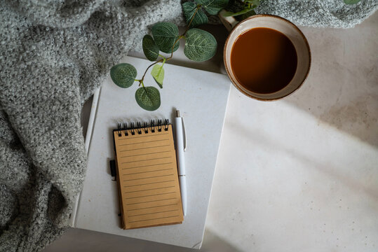 Planner notebook and cup of coffee on shadows background
