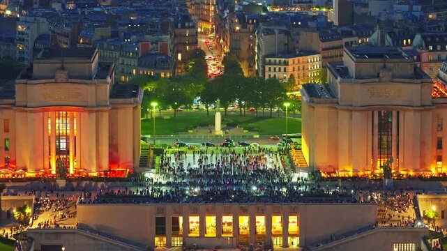 The center of Paris, Trocadero Square from the height of the Eiffel Tower. People walk and take pictures against the backdrop of the tower