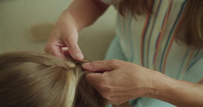 A Woman Braiding Hair A Tender Moment of Care, Connection, and Craftsmanship between Generations
