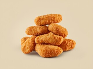 Crispy Golden Chicken Nuggets Stacked High - Delicious Fast Food Snack on Beige Background (Studio Shot)
