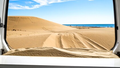 Sand dunes vista through van window