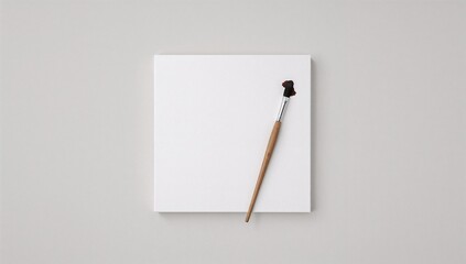Blank canvas and a brush, ready for painting. A moment of artistic inspiration. Simple and clean look.