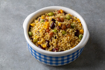 Bulgur pilaf with legumes; with peas, beans and corn kernels.