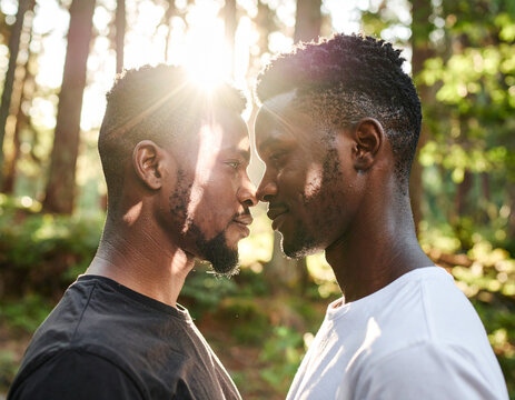 African American black gay man couple embracing in nature outdoors
