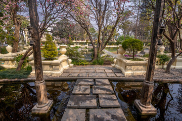 Tranquil view of the Garden of dreams in Kathmandu, Nepal. Beautiful landscaped garden with stone pathways, water fountains, blooming trees and elegant classical architecture offering a serene escape.