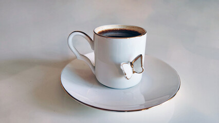 Turkish coffee served in a butterfly-patterned coffee cup