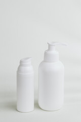White plastic pump dispenser bottles for cosmetics or medicine displayed on white background