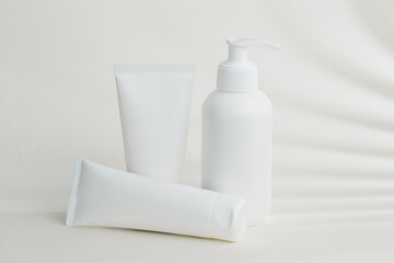 White plastic cosmetic packaging standing on white table