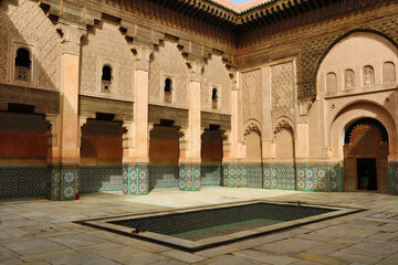 Moroccan Madrasa courtyard with pond - A wide shot of the beautiful courtyard of the Ben Youssef Madrasa, showing its central pond and detailed architecture.