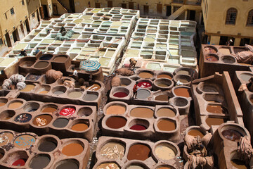 Fez Chouara Tannery Dye Pits - An elevated view of the iconic Chouara Tannery in the Fez Medina, featuring colorful dye pits and the ancient process of leatherworking.