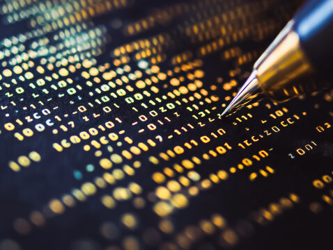Metallic pen is positioned above a colorful display of binary code, illustrating the fusion of technology and creativity, emphasizing the importance of digital communication in modern society