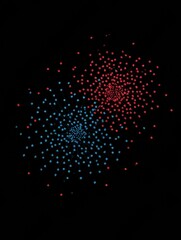 Colorful Fireworks Display Lighting up the Night Sky With Red and Blue Bursts Over a Dark Background During a Celebration