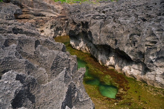 A cliff broken by the wave of the ocean. Natural azure bathing pool in the middle of the rock. A popular tourist spot on the island of Nusa Penida in Indonesia.