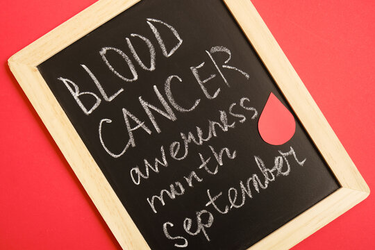 blood cancer concept, blood cancer awareness month, chalk writing on black board, red background