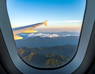 Fototapeta premium Airplane window view of mountains and clouds