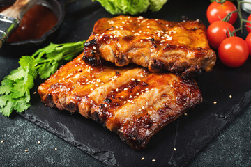 Barbecue pork spare ribs with hot honey chili marinade on black background