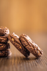 Sweet chocolate cookies on wooden table.