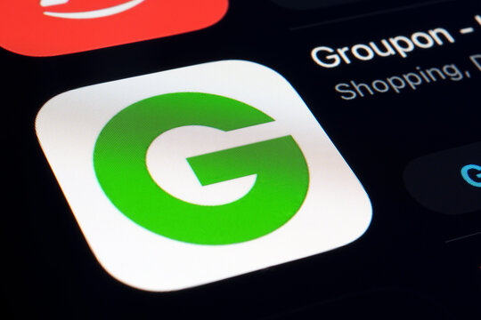 Groupon app logo on smartphone screen highlights discount marketplace connecting consumers with local deals and experiences. Stafford, United Kingdom, September 11, 2025.