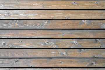 Texture from wooden boards with knots in weathered natural color. Aged background. Closeup.