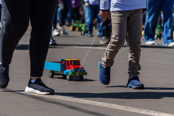 Child pulling a wooden cart in an Independence Day parade