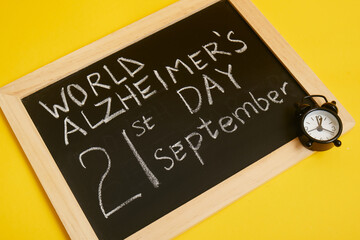 chalk board with inscription september 21 alzheimer's day, brain disease concept