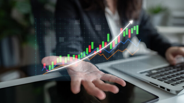 Business professional conducting financial analysis with digital data visualization in modern office. Laptop displays stock market trends and growth indicators. Impute - Powered by Adobe