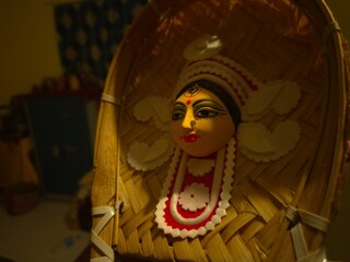 handcrafted wall hanging depicting the stylized face of Ma Durga, created for Durga Puja celebrations.