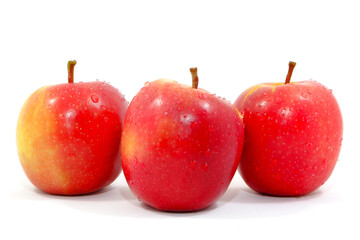 Fresh red apples together on white background close up view