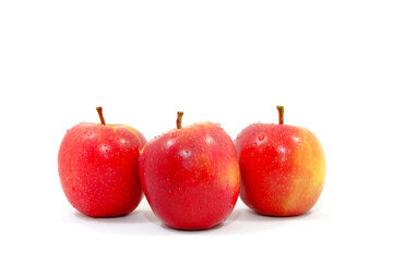 Fresh red apples together on white background close up view