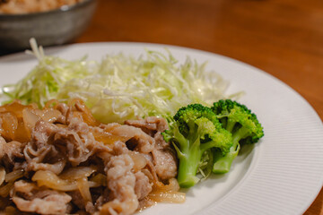 Japanese dinner with pork ginger stir fry and shredded cabbage
